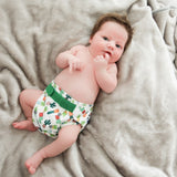 Baby in succulents reusable newborn nappy on soft rug